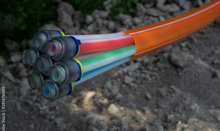 underground utility cable bundle with red wrapper